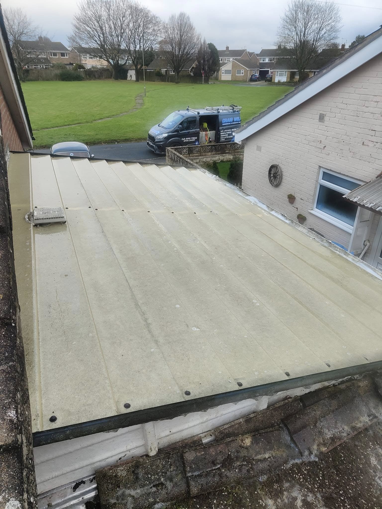The same conservatory roof clean, the van parked on the street beyond