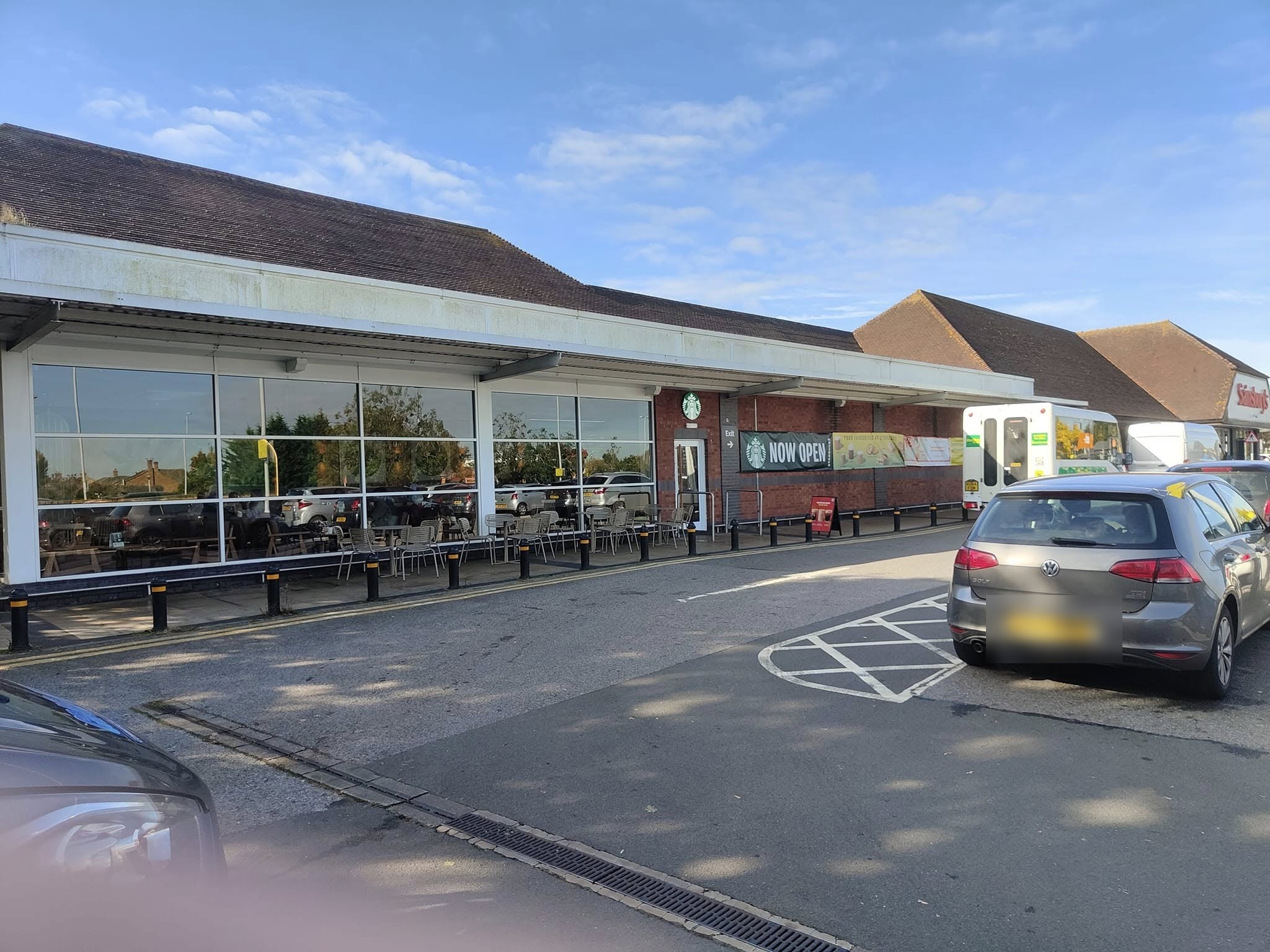 Long glazed shopfront of a supermarket cafe with the car park in front