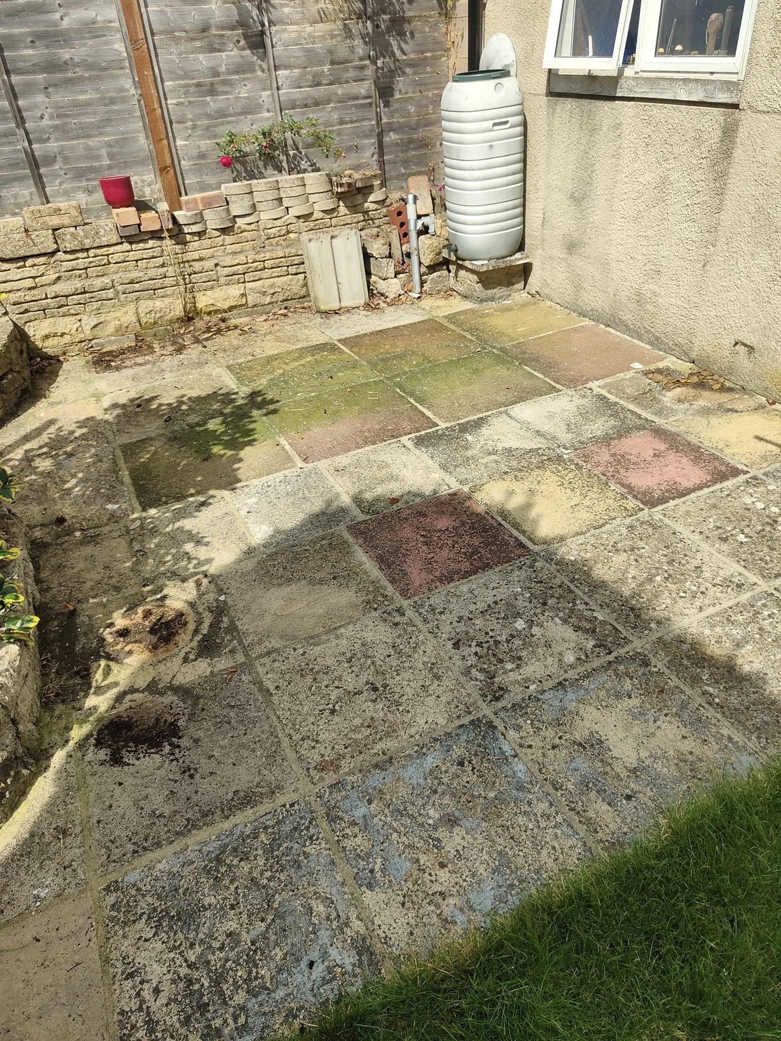 Patio with mossy, stained slabs