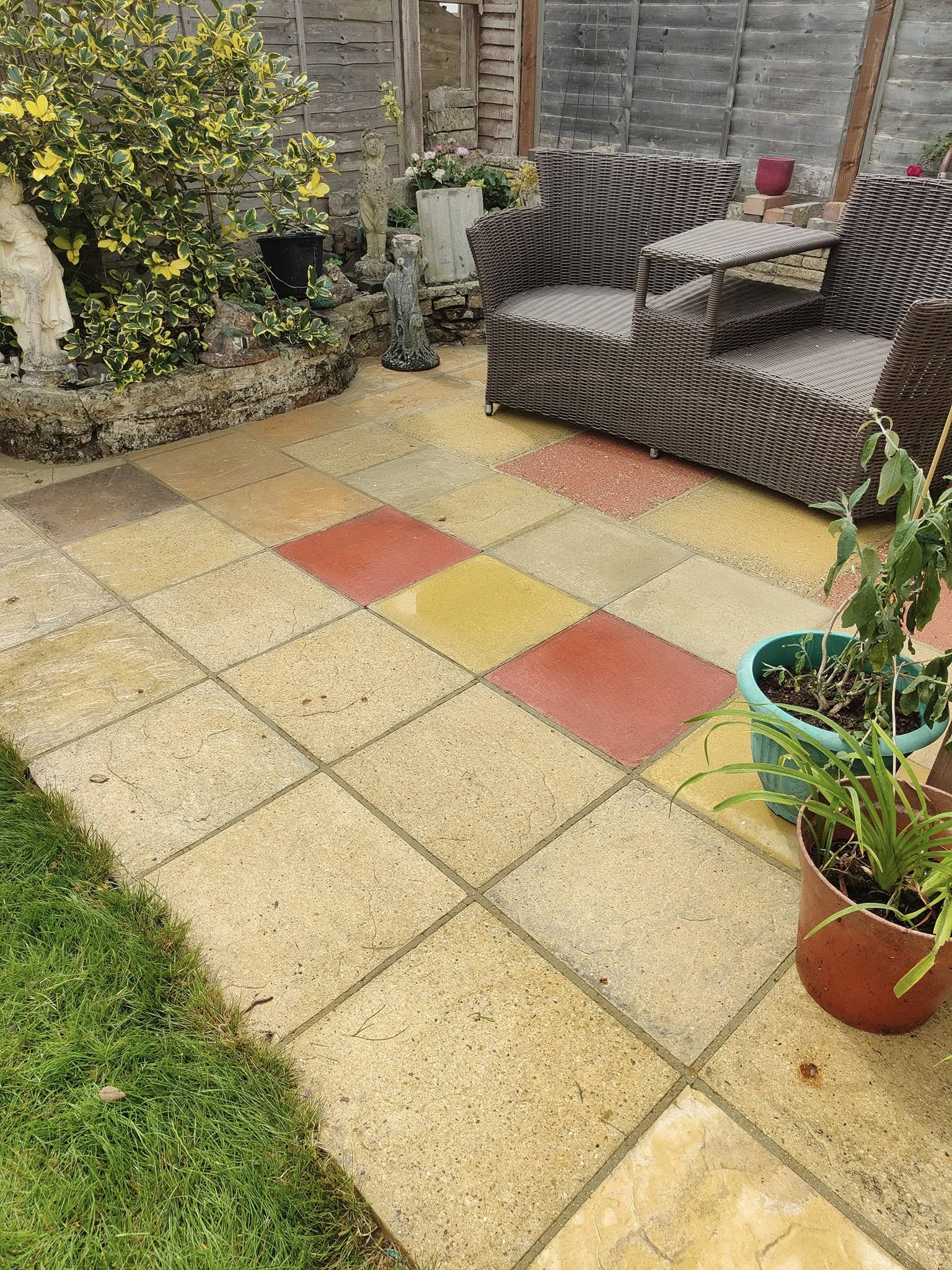 Clean patio with coloured slabs and garden furniture