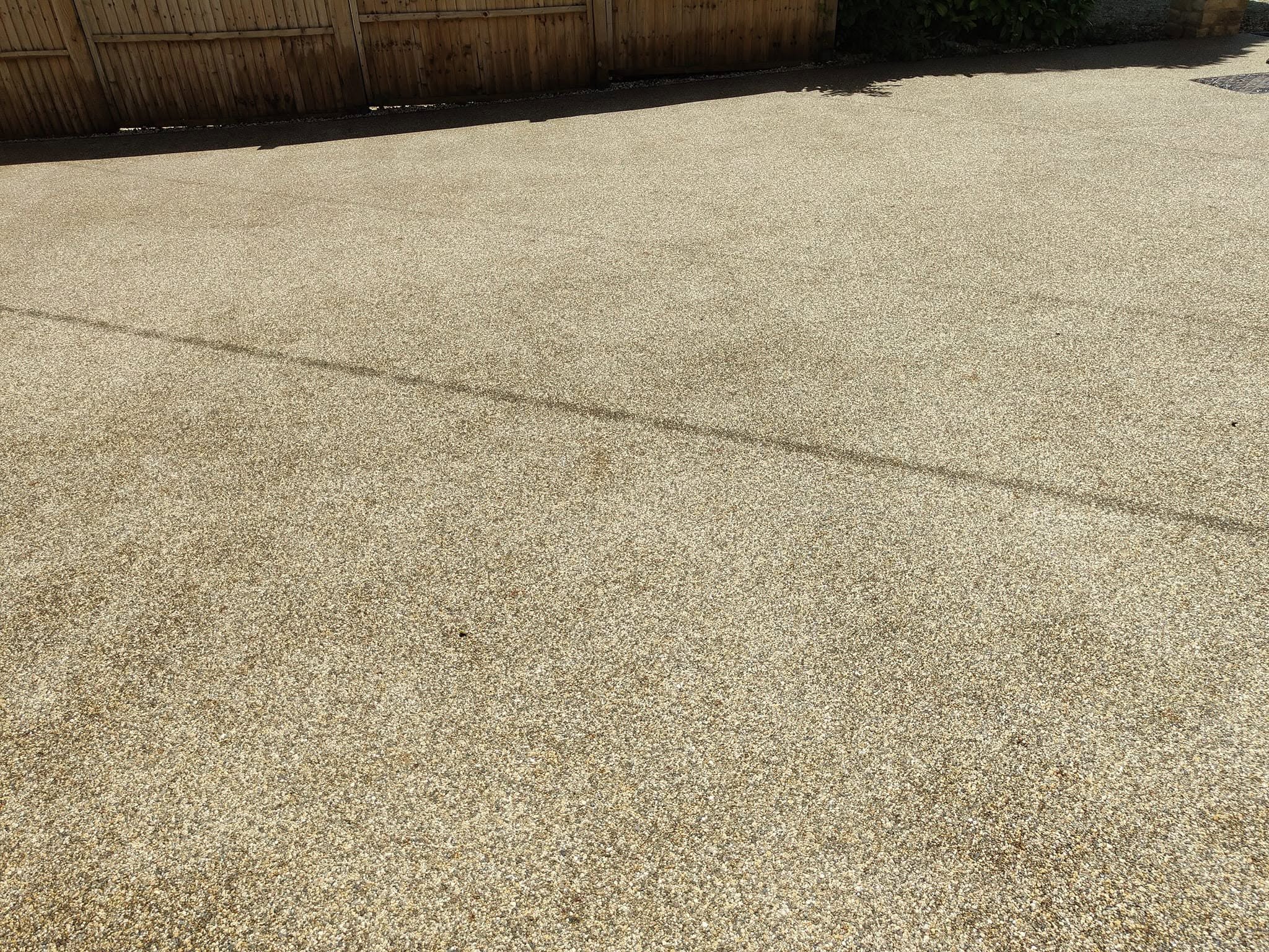 Wide gravel-finish drive evenly clean after jet washing