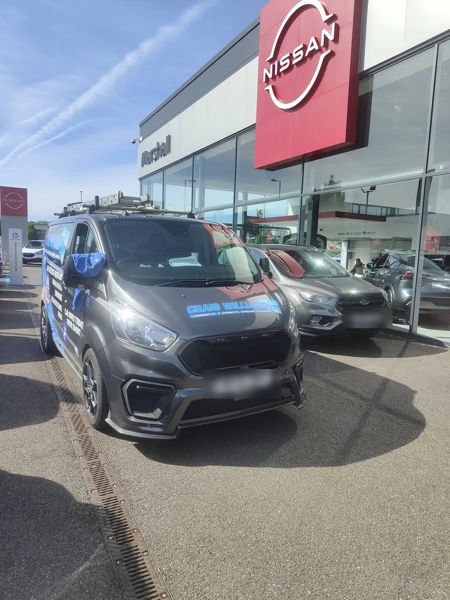 The Craig Williams van parked outside a car showroom