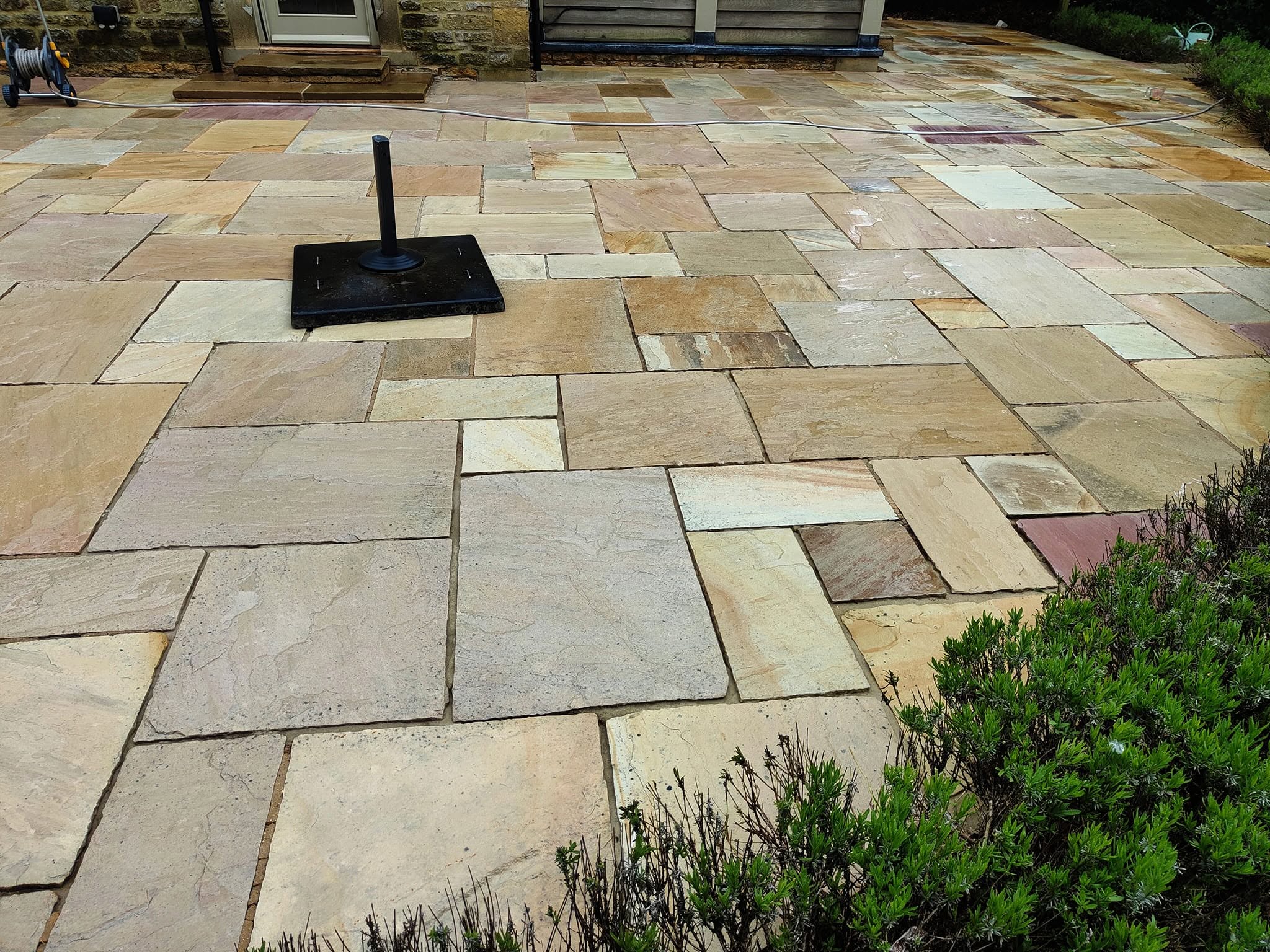 Stone patio slabs clean and dry after jet washing