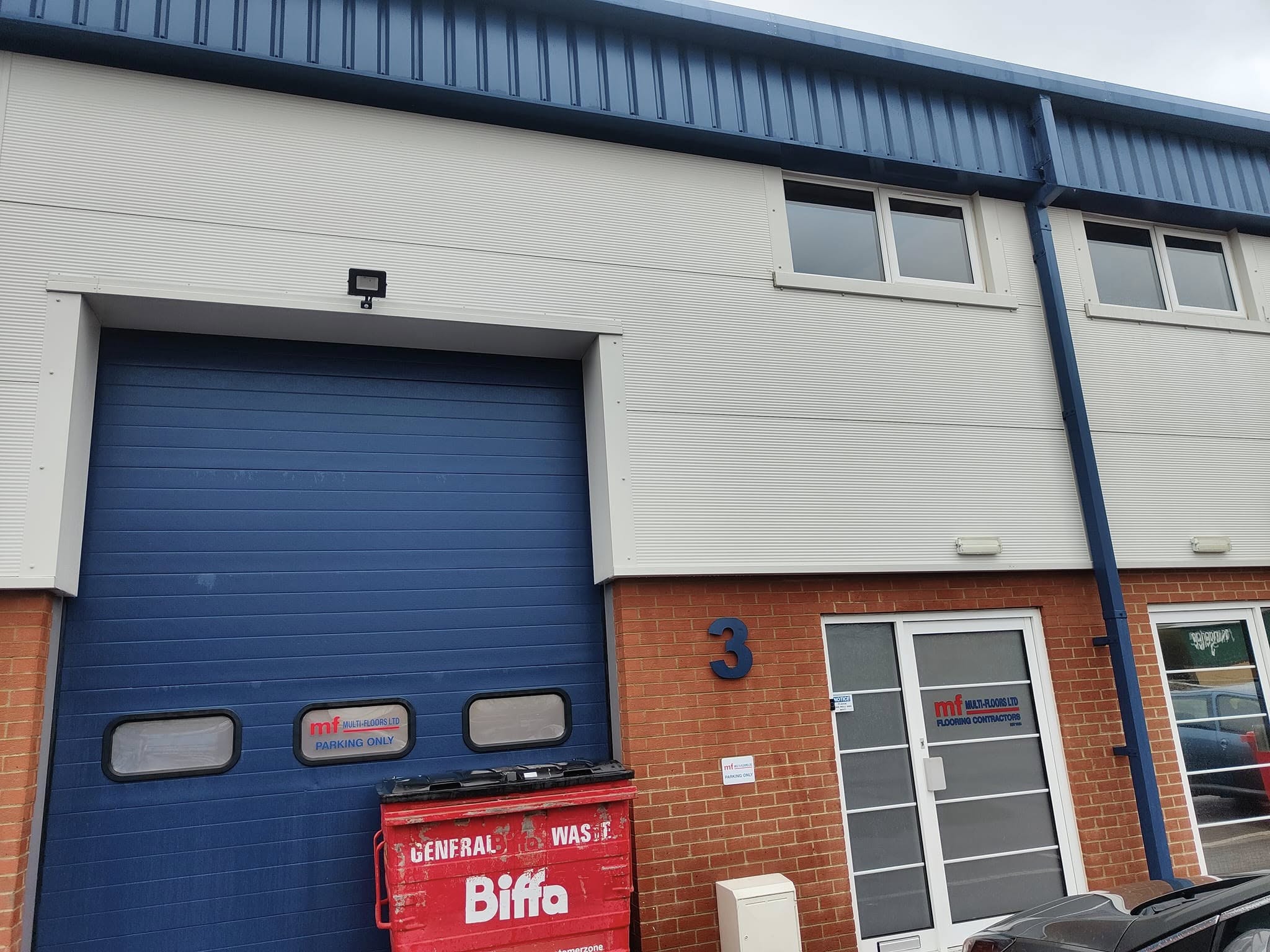 Industrial unit front with grimy cladding before cleaning
