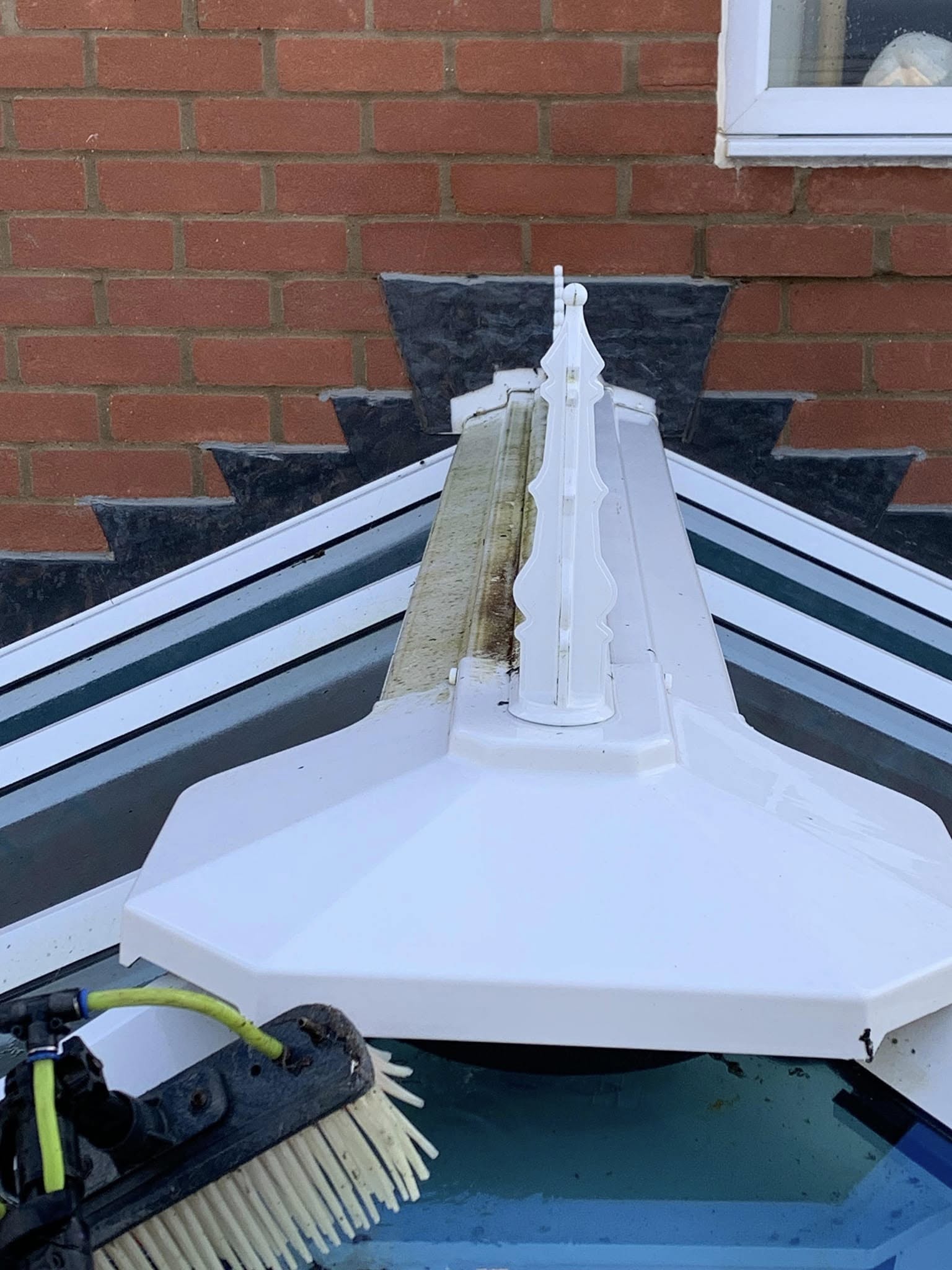 Conservatory roof finial half cleaned, showing the difference