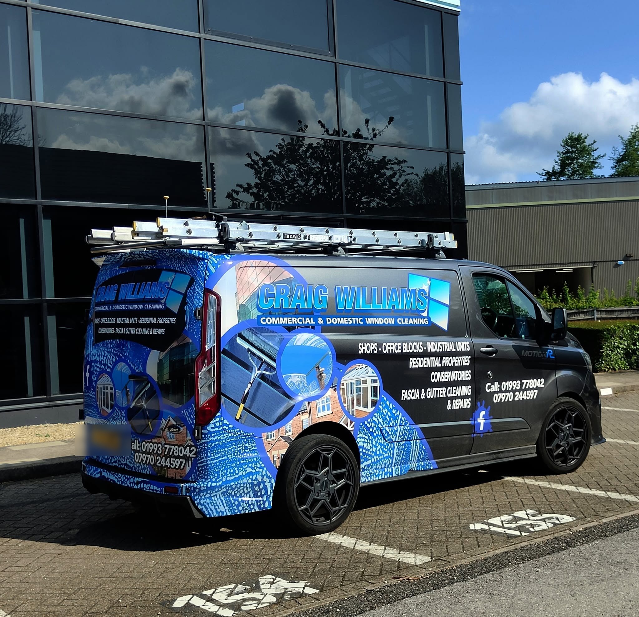 The Craig Williams van from the rear, ladders on the roof rack