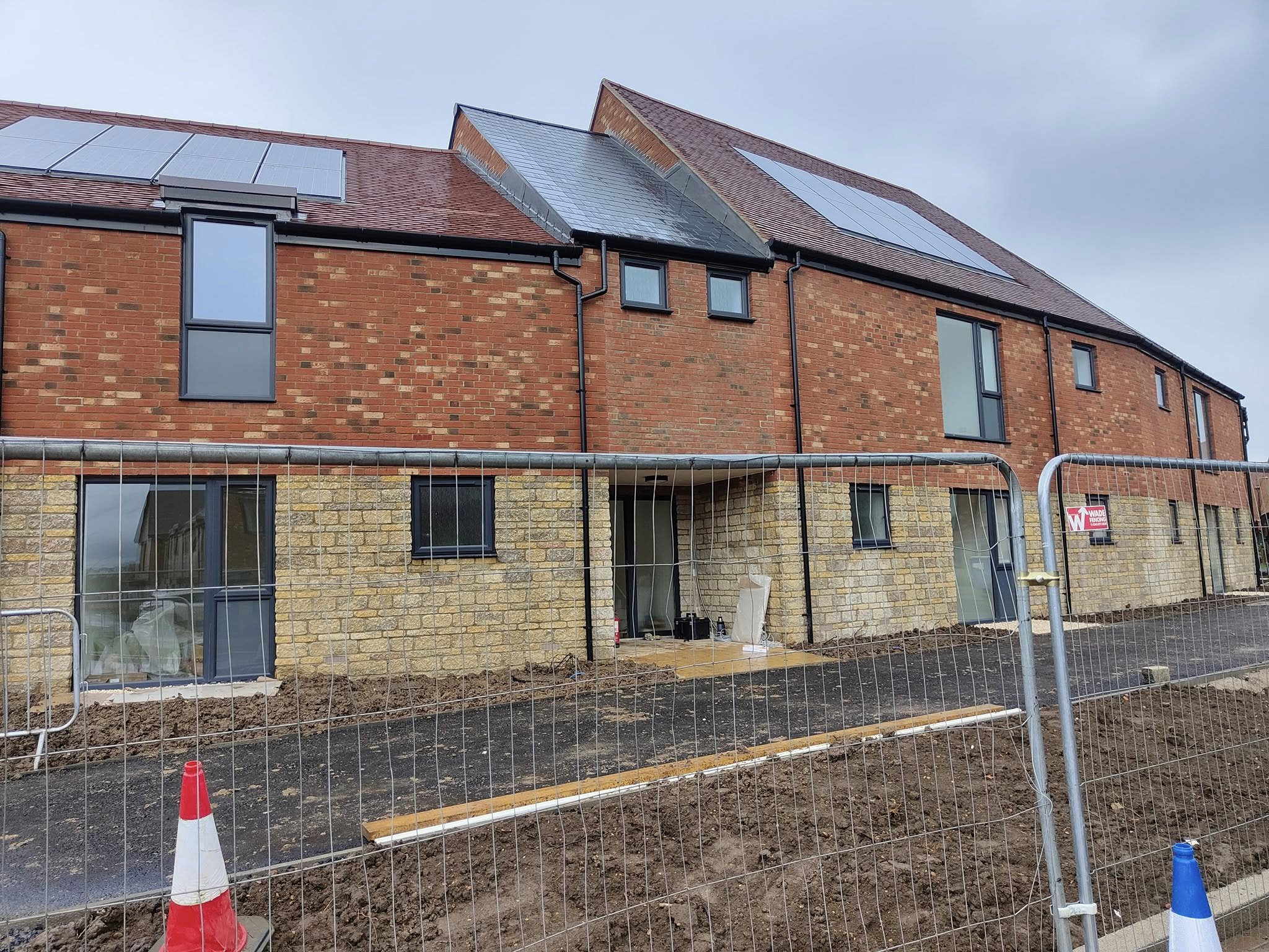 New-build homes with ladders up at the windows
